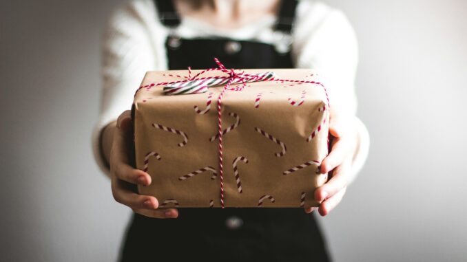 person showing brown gift box