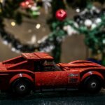 a red toy car sitting on top of a table
