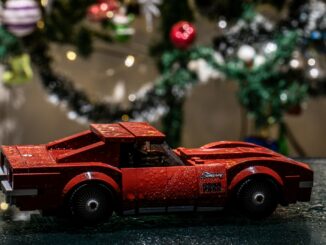 a red toy car sitting on top of a table