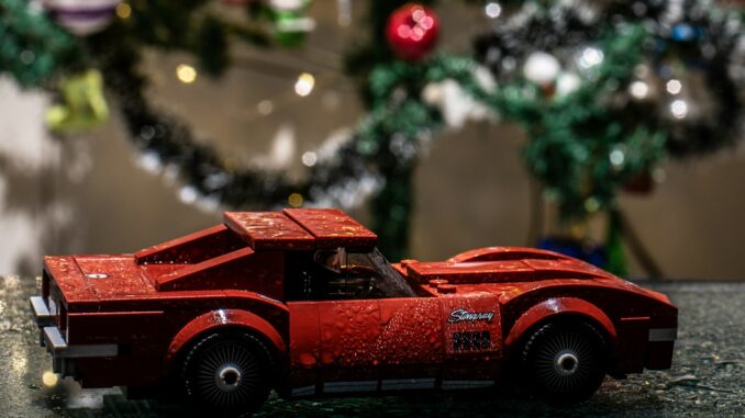 a red toy car sitting on top of a table